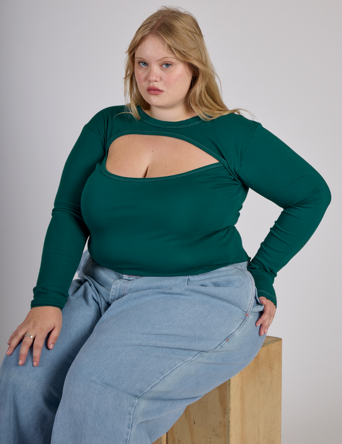 Juliet wearing the Hunter Green Long Sleeve Porthole Tee with Light Wash Denim Wide Leg Trousers