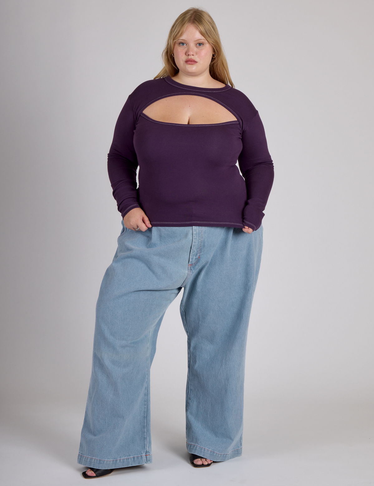 Juliet wearing the Nebula Purple Long Sleeve Porthole Tee with Light Wash Denim Wide Leg Trousers