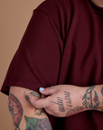 Burly Tee in Red Wine sleeve close up on Sam