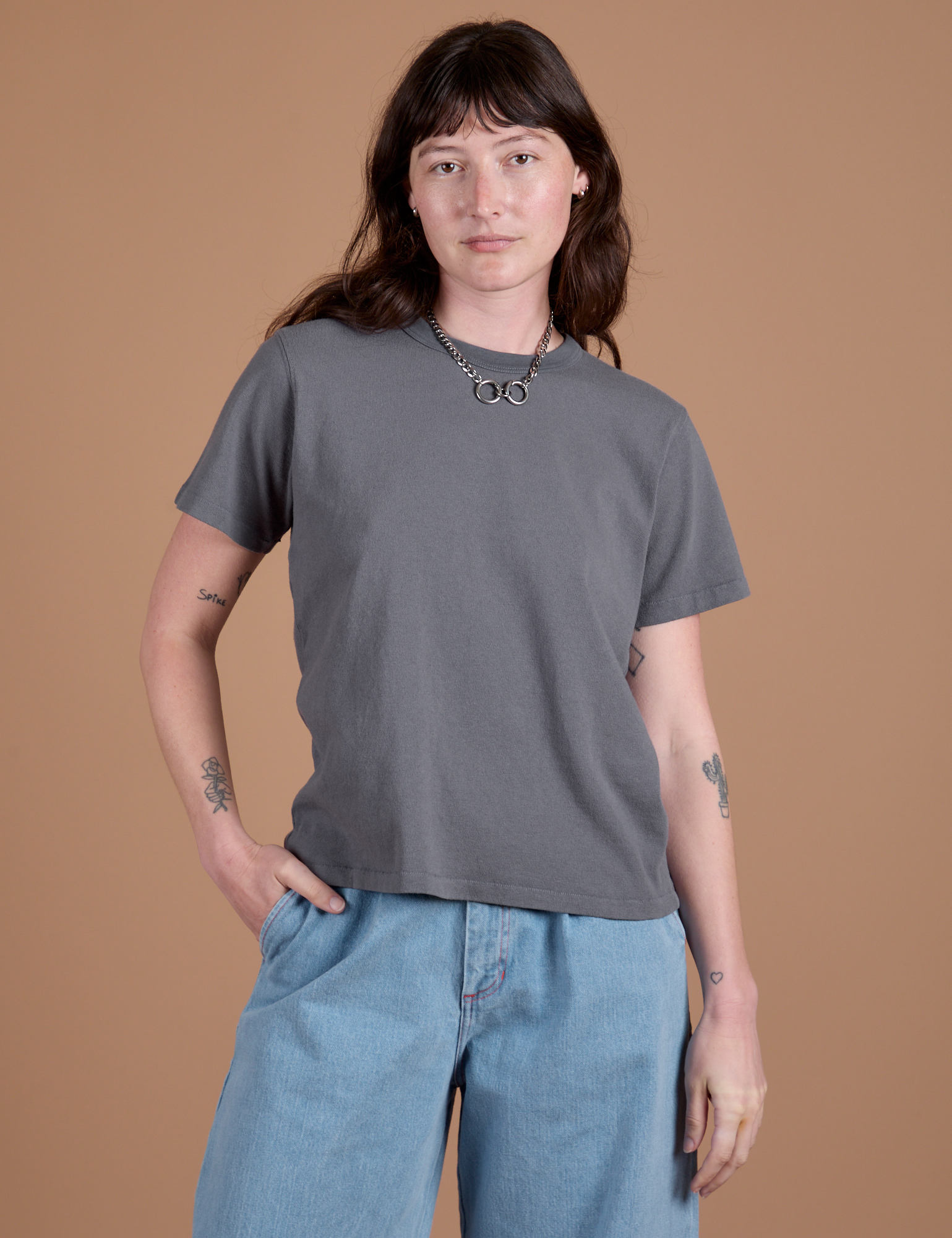 Alex is wearing Burly Tee in Washed Grey