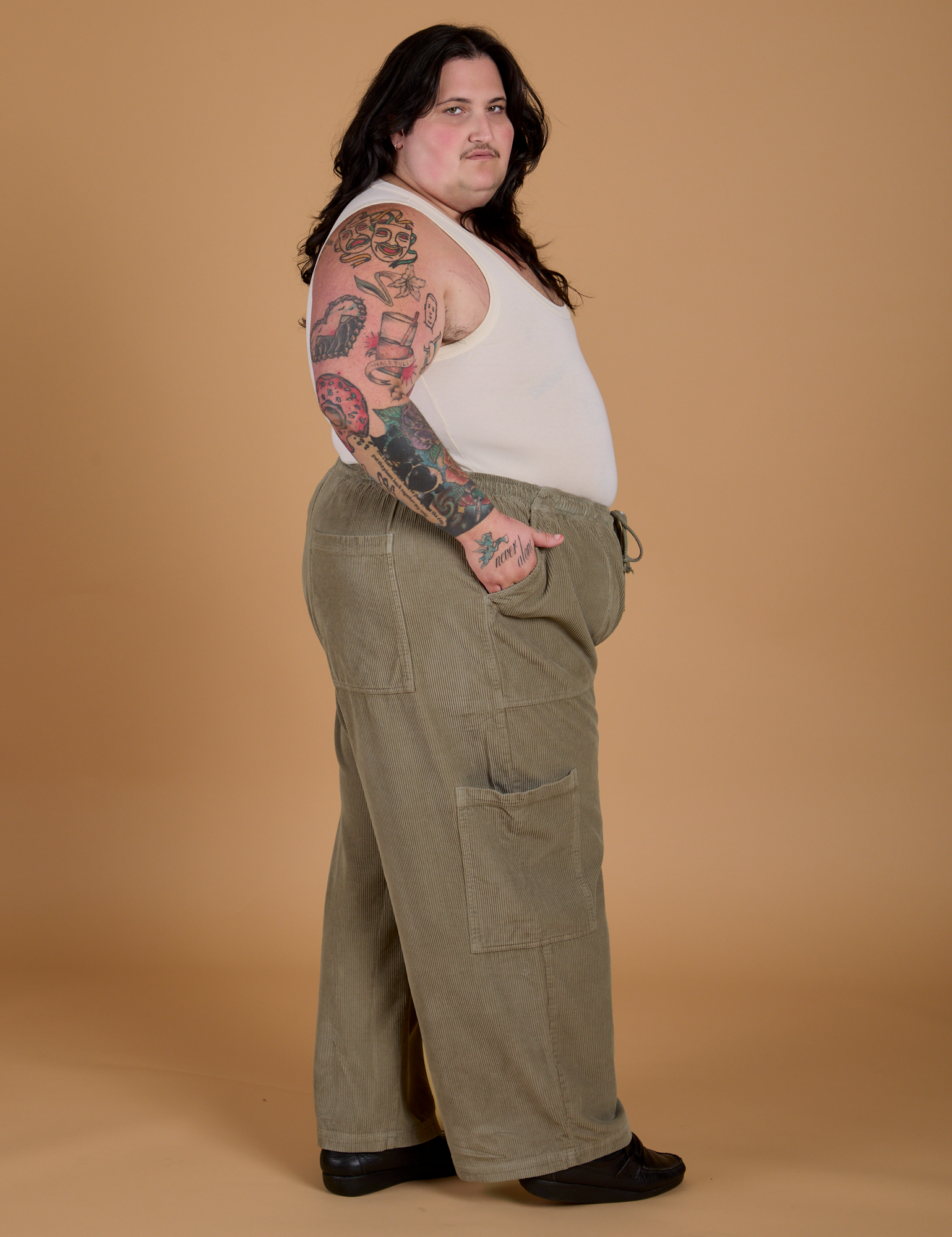 Side view of Corduroy Drop Pocket Cargo Pants in Khaki Grey and Tank Top in Vintage Tee Off-White on Sam