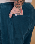 Close up of Sam's hand in the back pocket of Corduroy Drop Pocket Cargo Pants in Lagoon