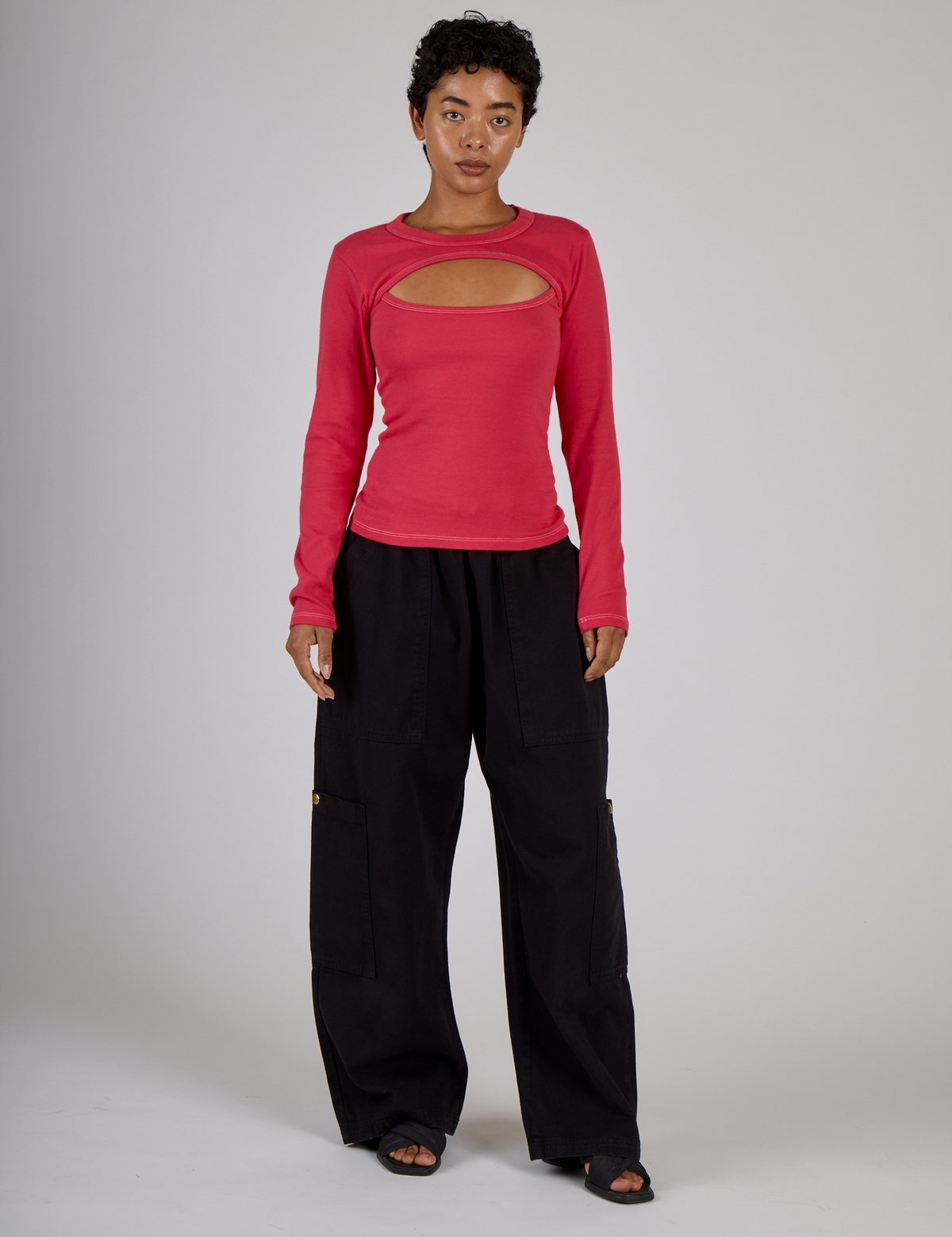 Mika is 5'3" and wearing P Hot Pink Long Sleeve Porthole Tee with Black Drop Pocket Pants