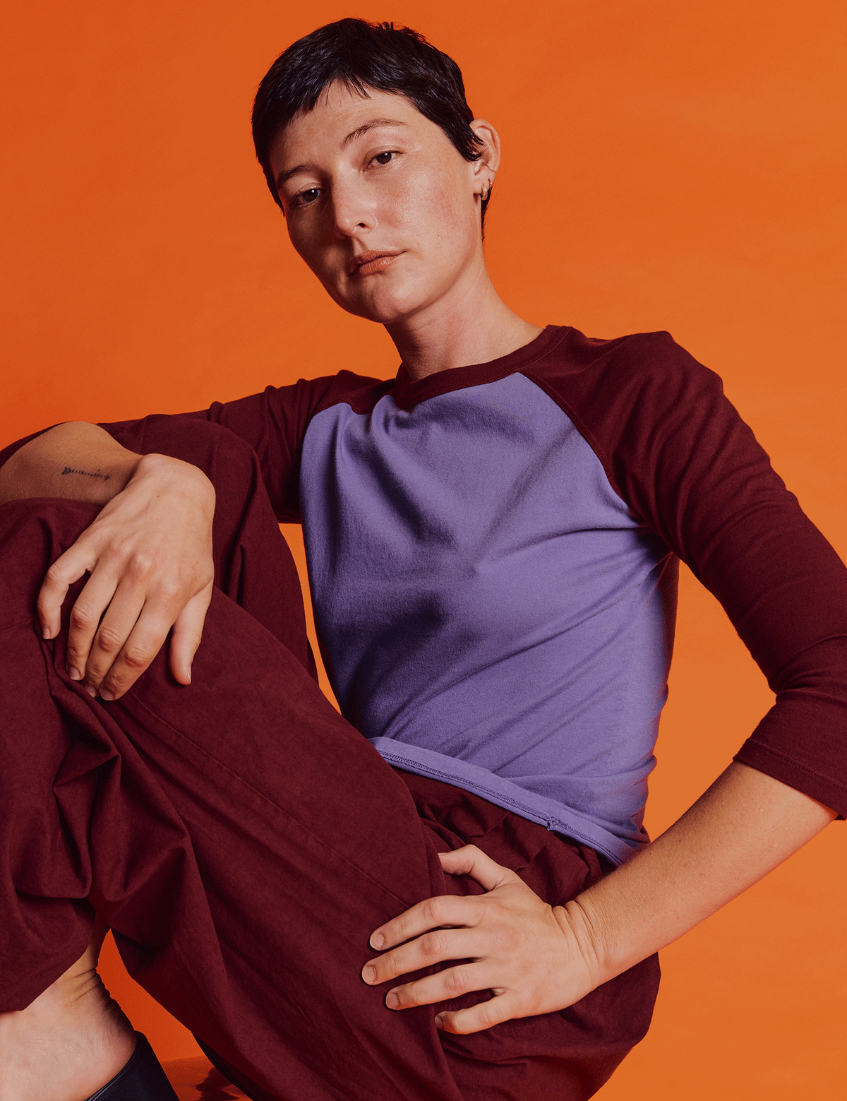 Alex is 5'8" and wearing P Faded Grape/Wine Colorblock Raglan Tee