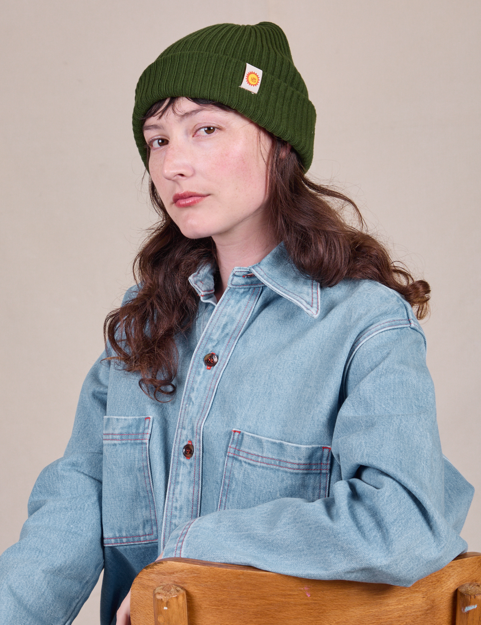 Alex is wearing Ribbed Beanie in Evergreen