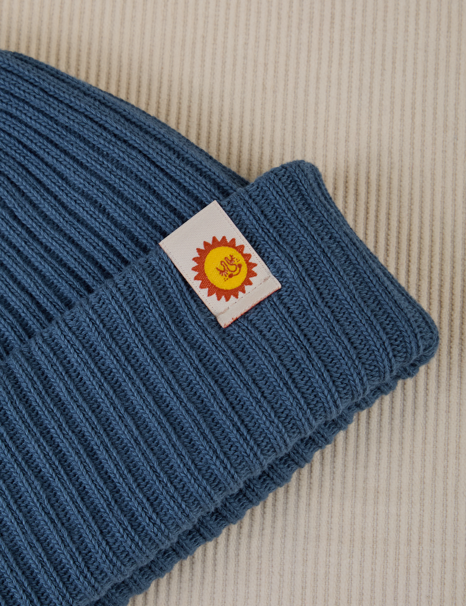 Ribbed Beanie in French Blue close up sun baby tag