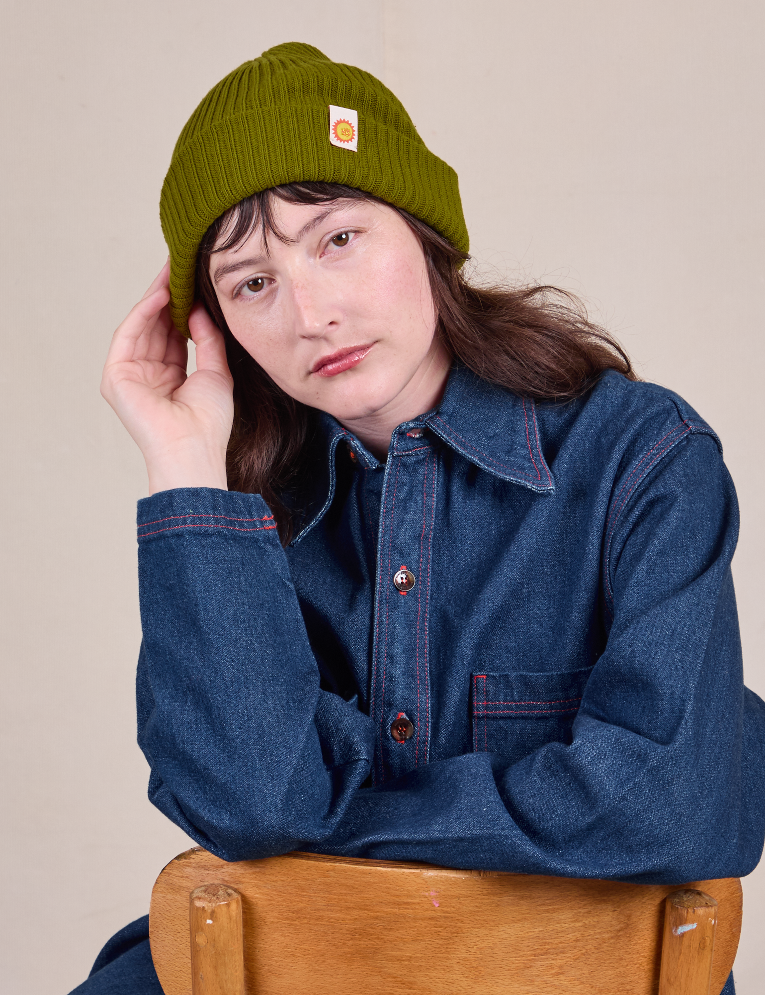 Alex is wearing Ribbed Beanie in Olive Green