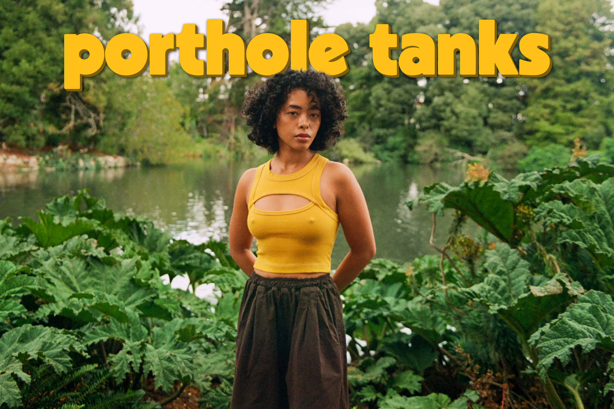 Mika is wearing the Porthole Tank in Mustard Yellow and Pleated Pull-On Pants in Espresso Brown