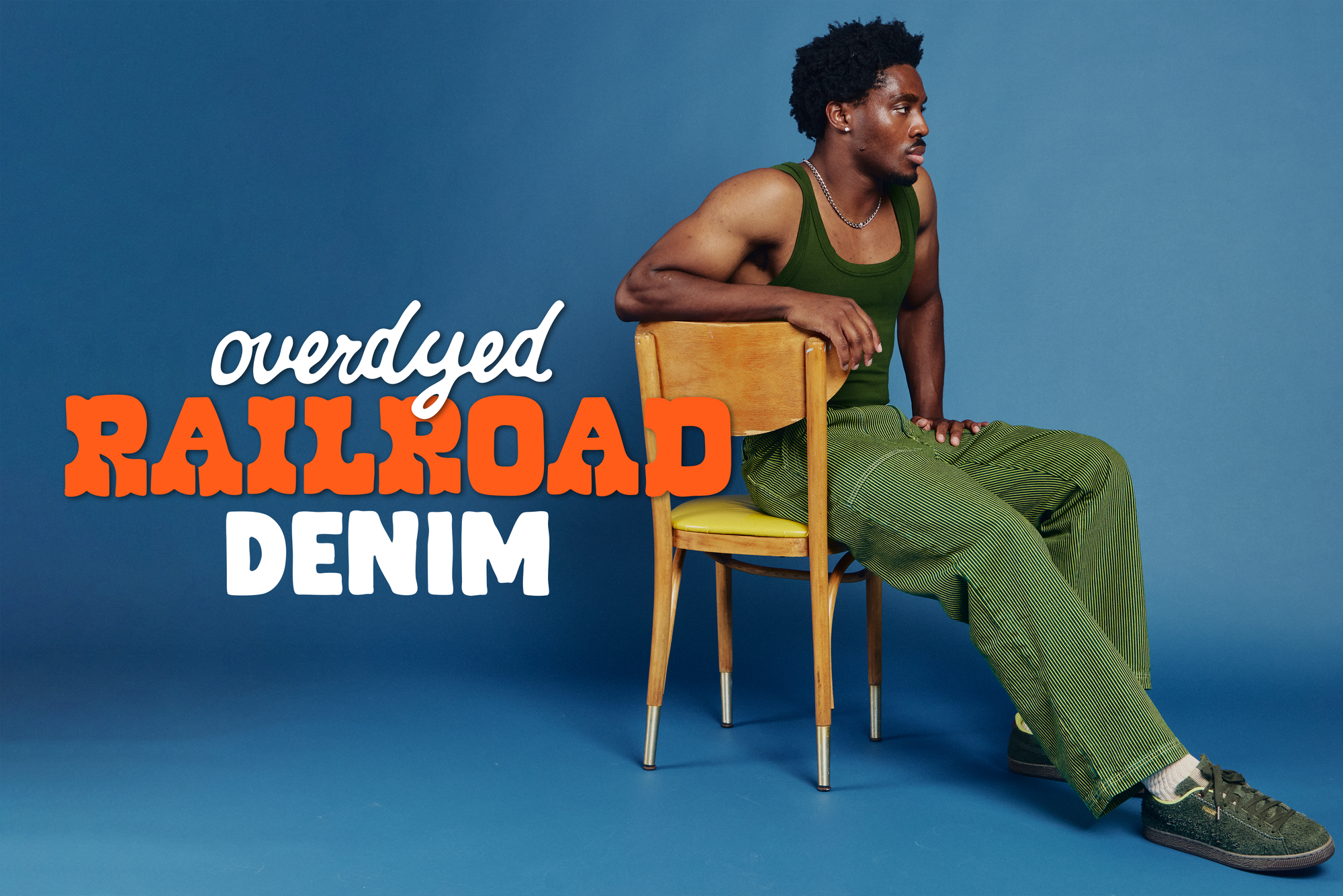 Isaac is wearing Railroad Denim Work Pants in gross green overdyed
