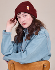 Alex is wearing Ribbed Beanie in Red Wine