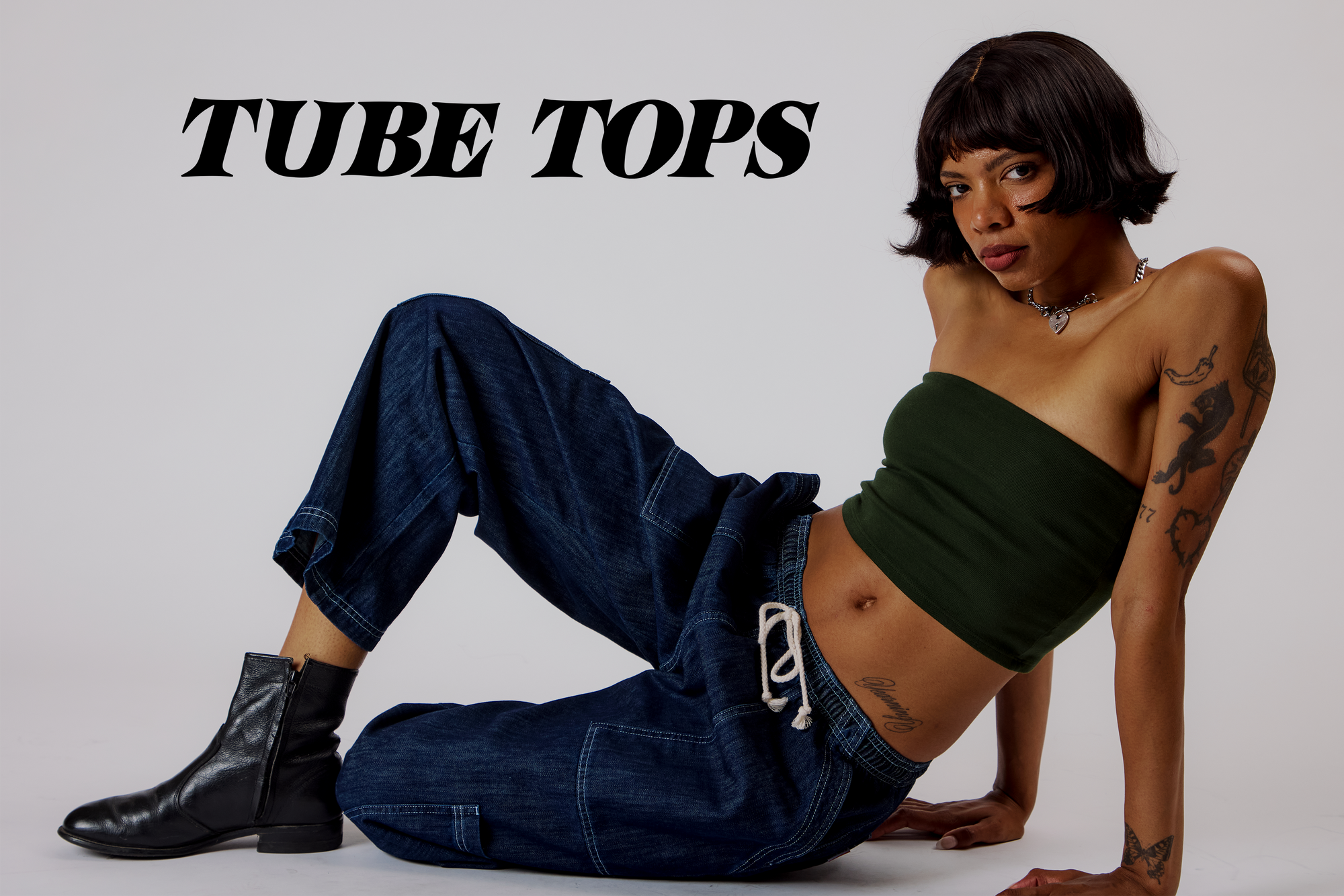 Kira is wearing a Tube Top in Evergreen paired with Dark Wash Drop Pocket Pants